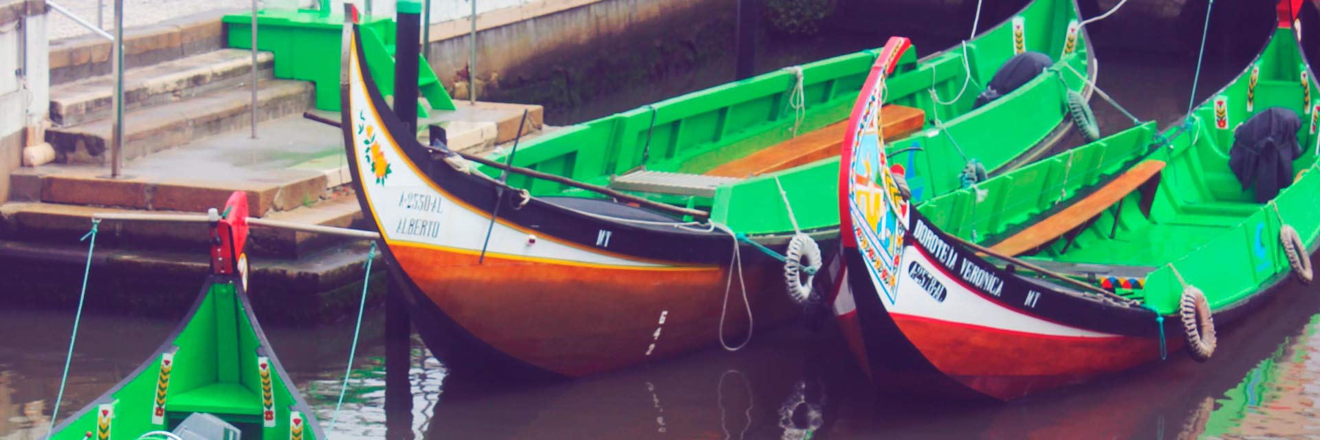 Two moliceiro boats next to the pier.