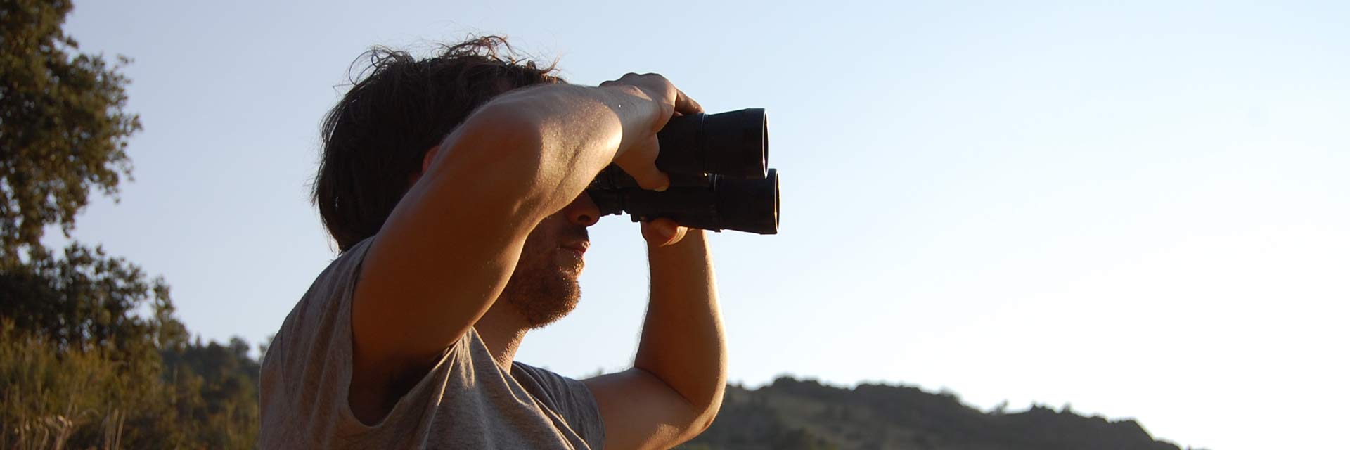 Man looking through binoculars.