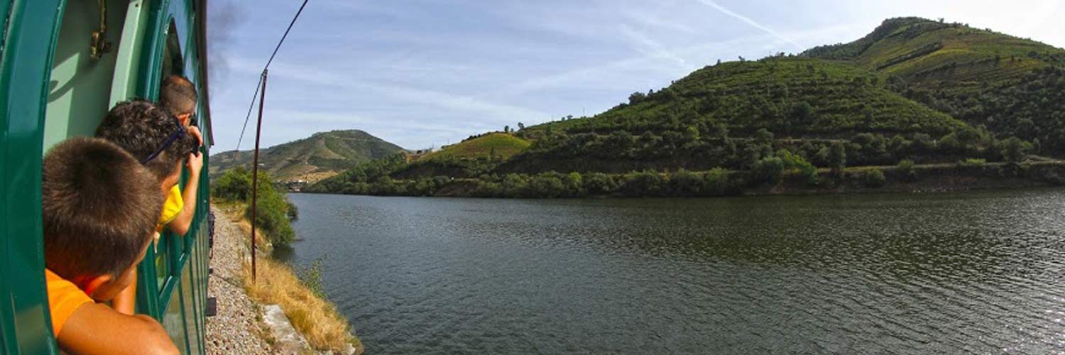 Children loooking out the train window at the River Douro 