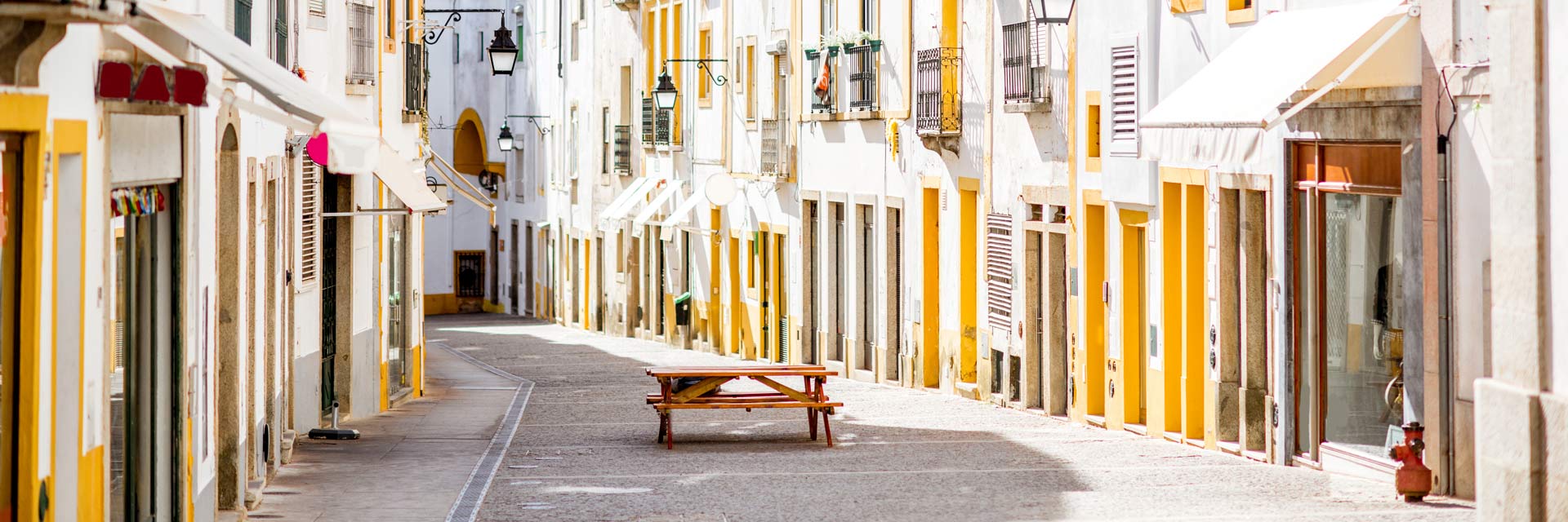 A street in the historic center with white houses and yellow doorways.