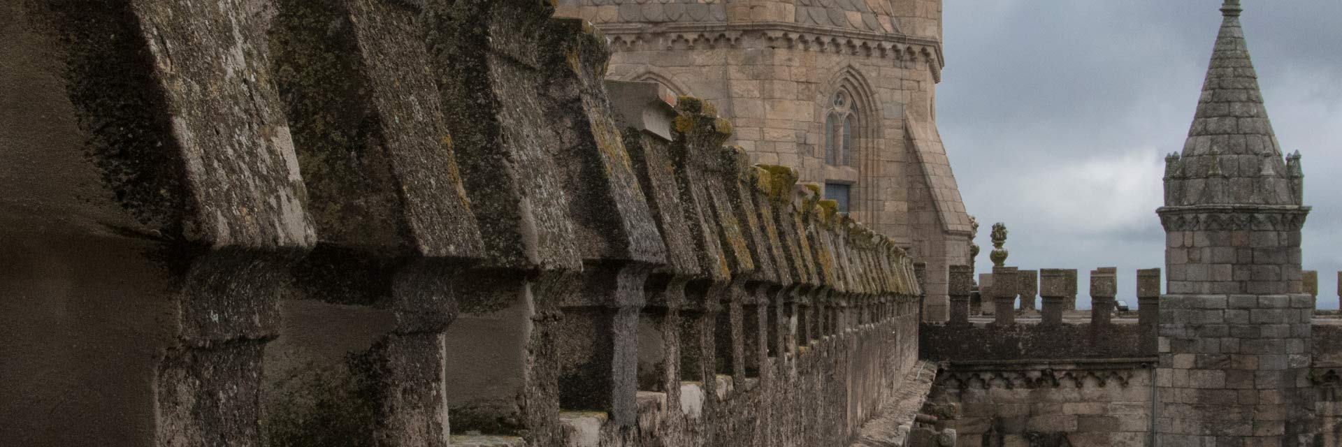 Top of Évora Cathedral with walls and one of the large and one small towers.