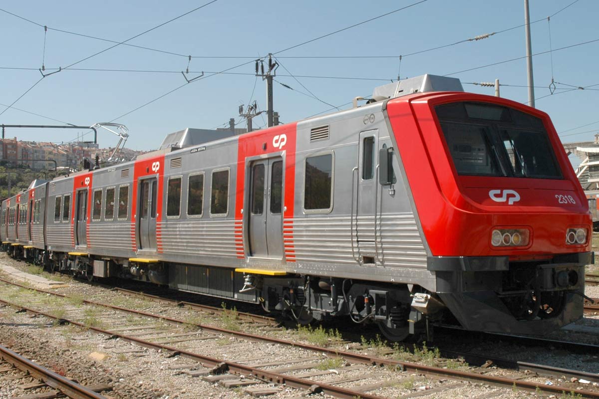 CP 2300 series electric unit with red and grey livery, parked on one of the station lines.