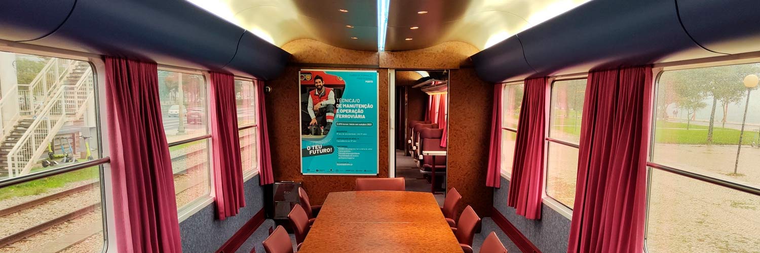 Interior of the VIP coach with a table and chairs for meetings.