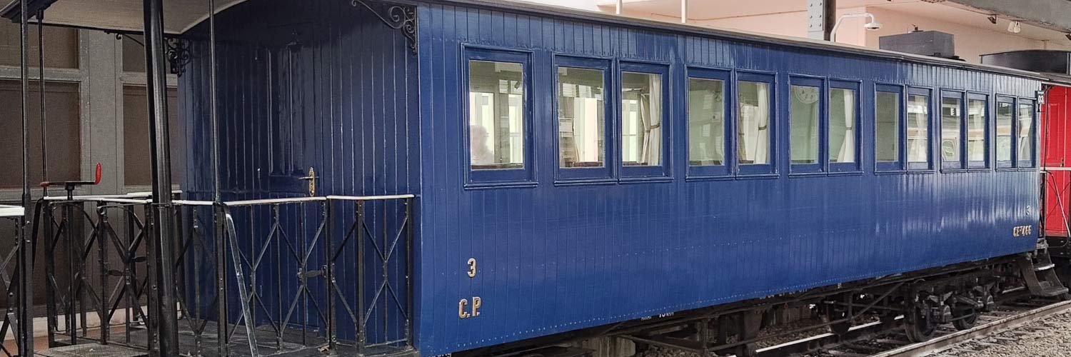 CEyf 466 narrow gauge passenger coach with blue livery stopped at the station.