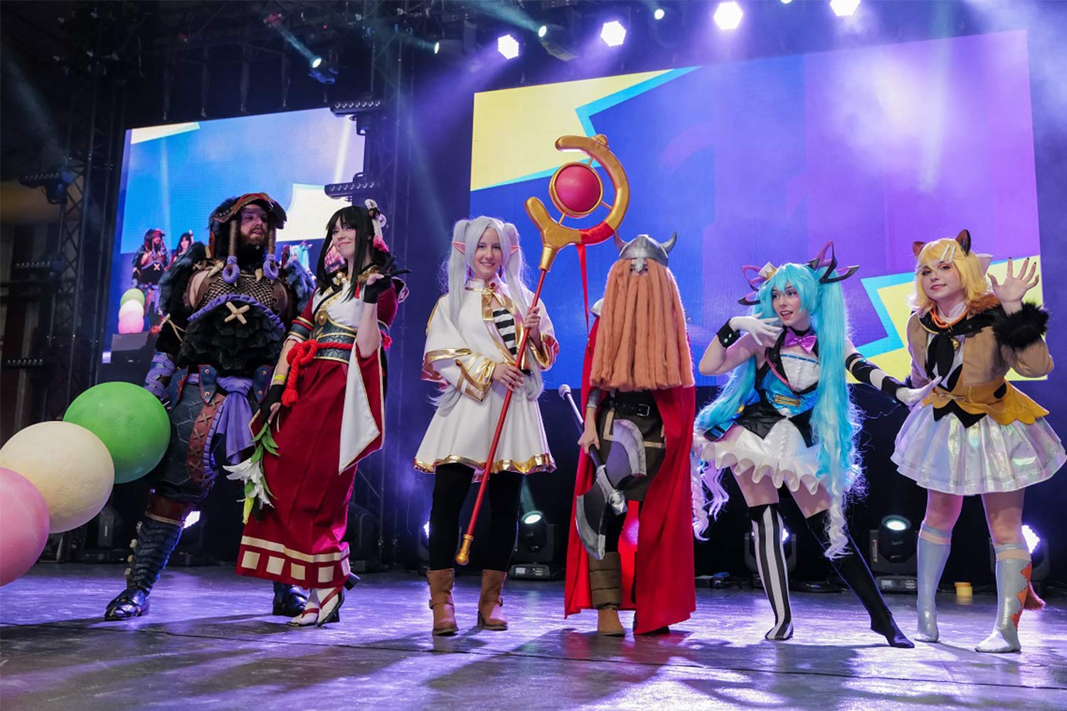 People in costume on stage.